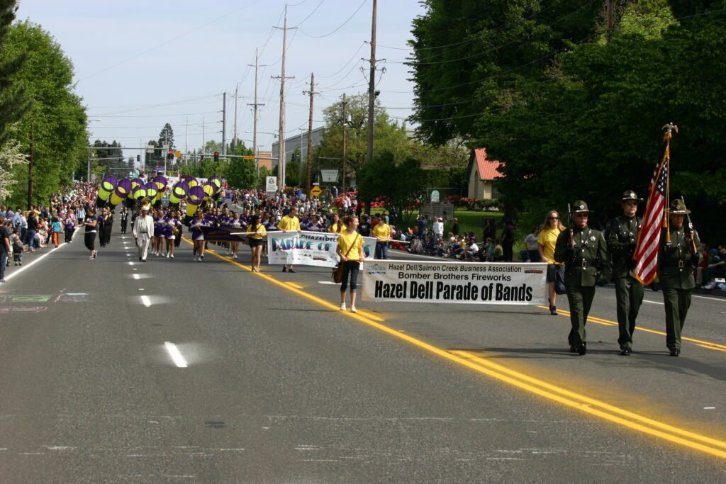 Hazel Dell Parade of Bands with color guard and marching band on Vancouver, WA street