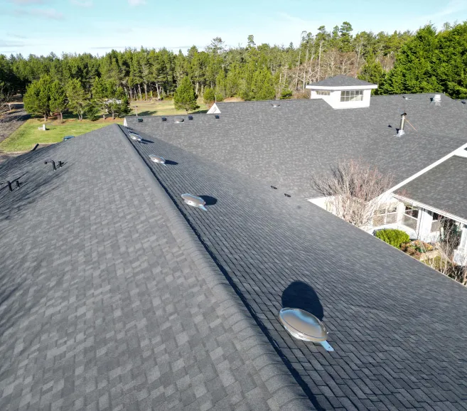Aerial view of asphalt shingle roof with roof vents and cupola near Salmon Creek