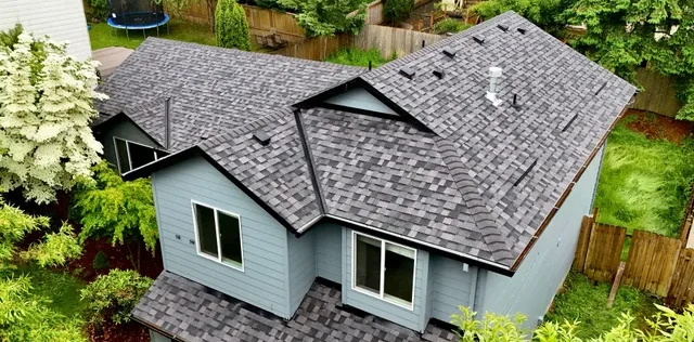 Aerial view of light blue home with new asphalt shingle roof in Vancouver, WA
